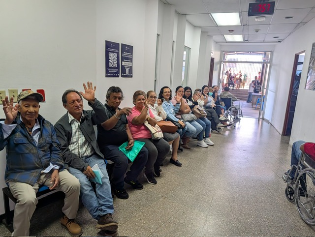 Patients waving from a hospital hallway as they wait their turn