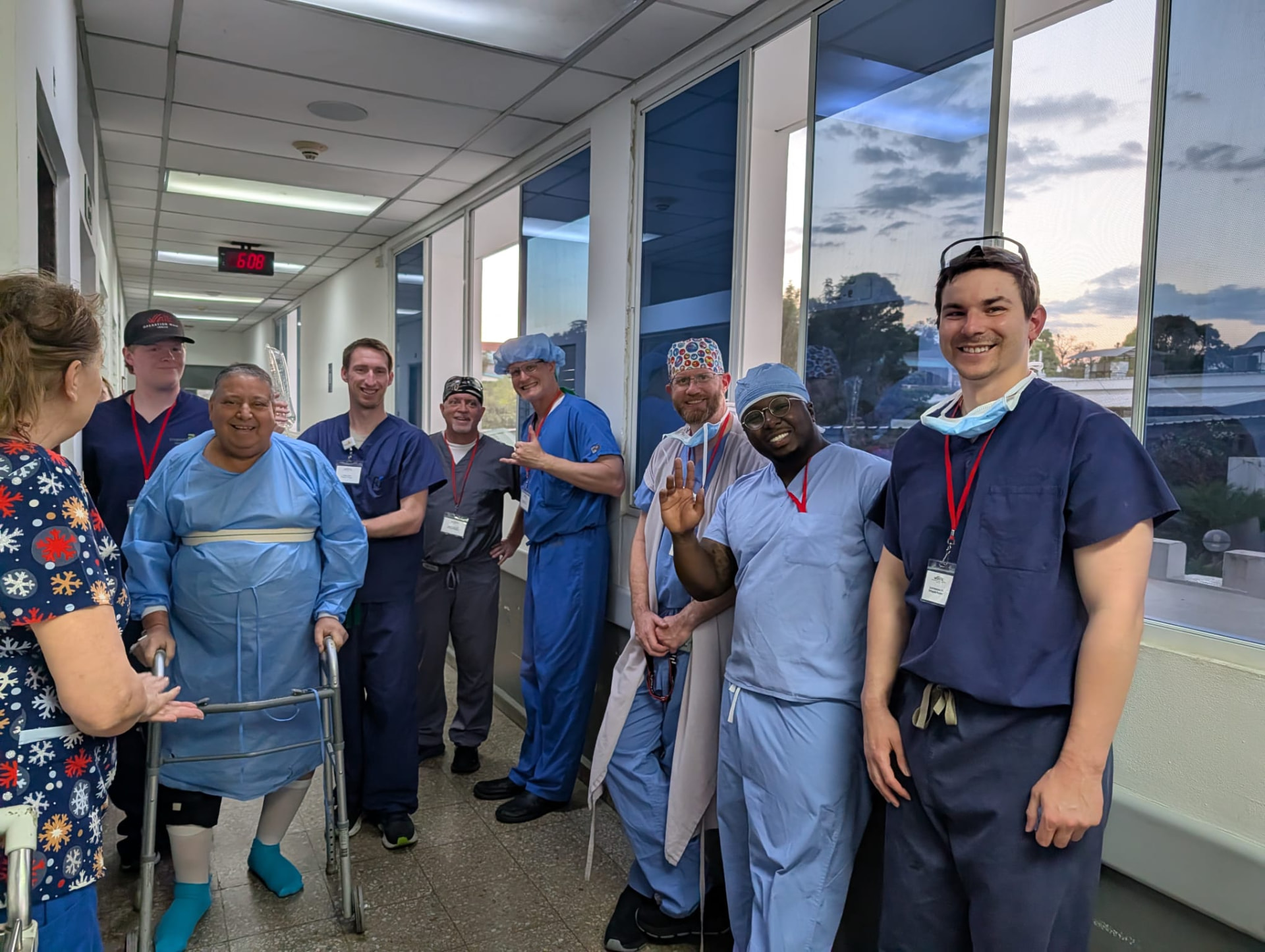 The Operation Walk team celebrating with a patient taking her first steps